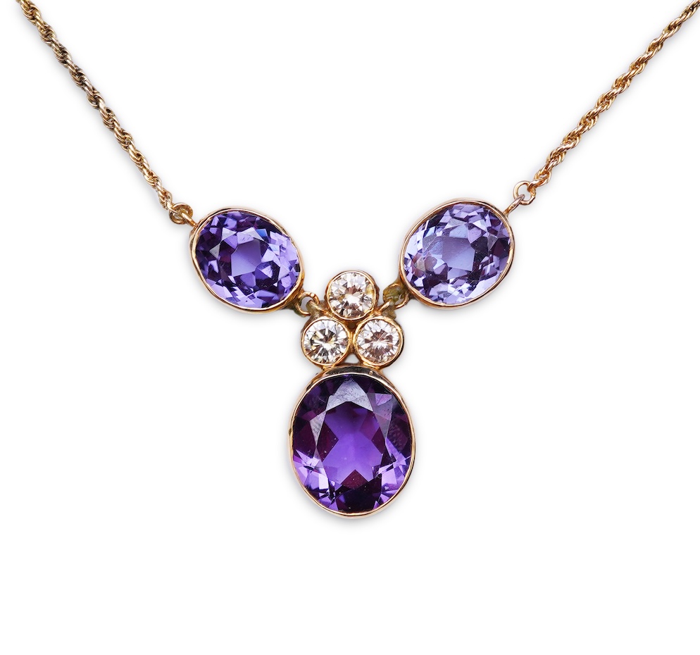 A synthetic colour-change sapphire and diamond pendant necklace